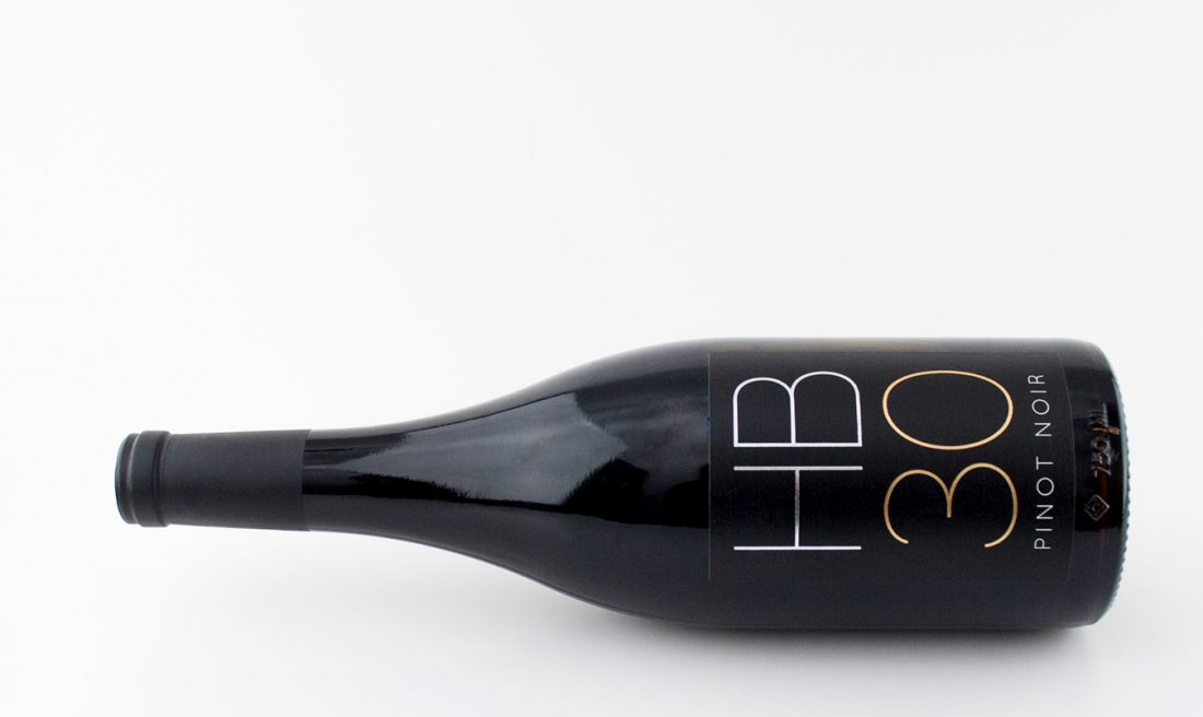 Bottle of wine with GB 30 Pinot Noir printed on the label.