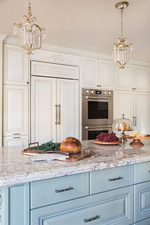Traditional Kitchen Remodel by HartmanBaldwin - Hartman Baldwin Pre-Launch Custom kitchen remodel featuring blue and white cabinetry, brass-accented light fixtures, and stainless steel appliances.