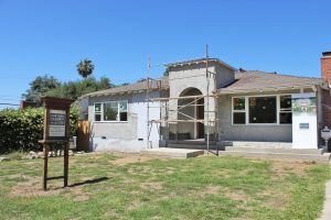 Exterior of new HartmanBaldwin project. Scaffolding in front of door with HartmanBaldwin signage.