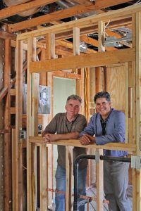 HartmanBaldwin staff presenting new project inside with exposed framing.