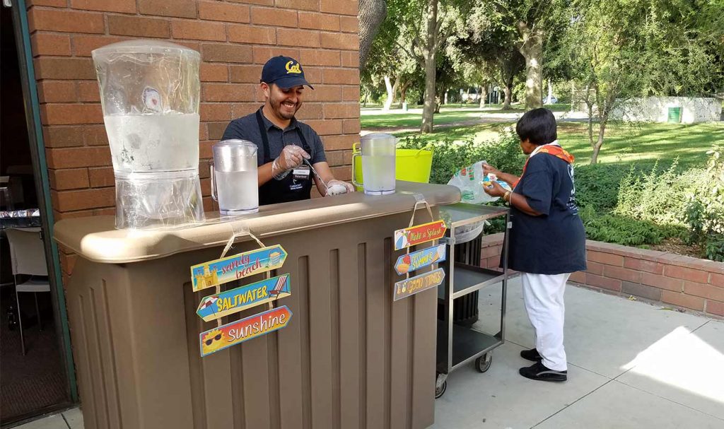 HartmanBaldwin staff working at a bar providing water to volunteer staff.