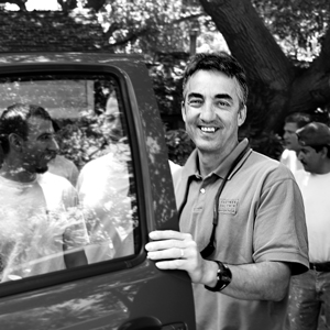 Rob Abersek opening a car door. Black and white image.