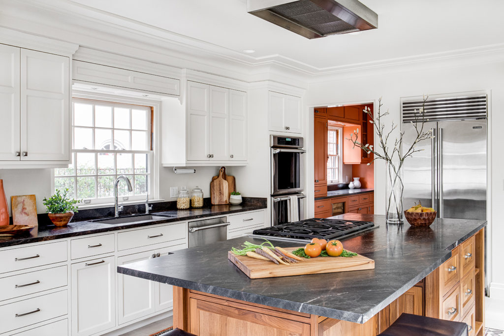 Close up view of a luxury kitchen island as part of an English cottage style kitchen remodel