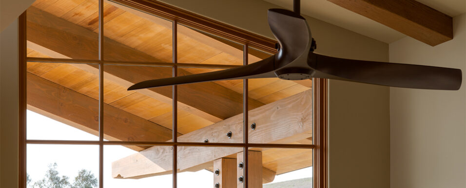 New custom home large wood-frame clerestory window with structural beams seen beyond