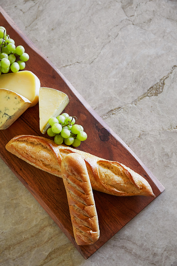 HartmanBaldwin Mira Monte Residence Craftsman Style Kitchen Charcuterie Charcuterie board on cream stone countertop with elegant veining