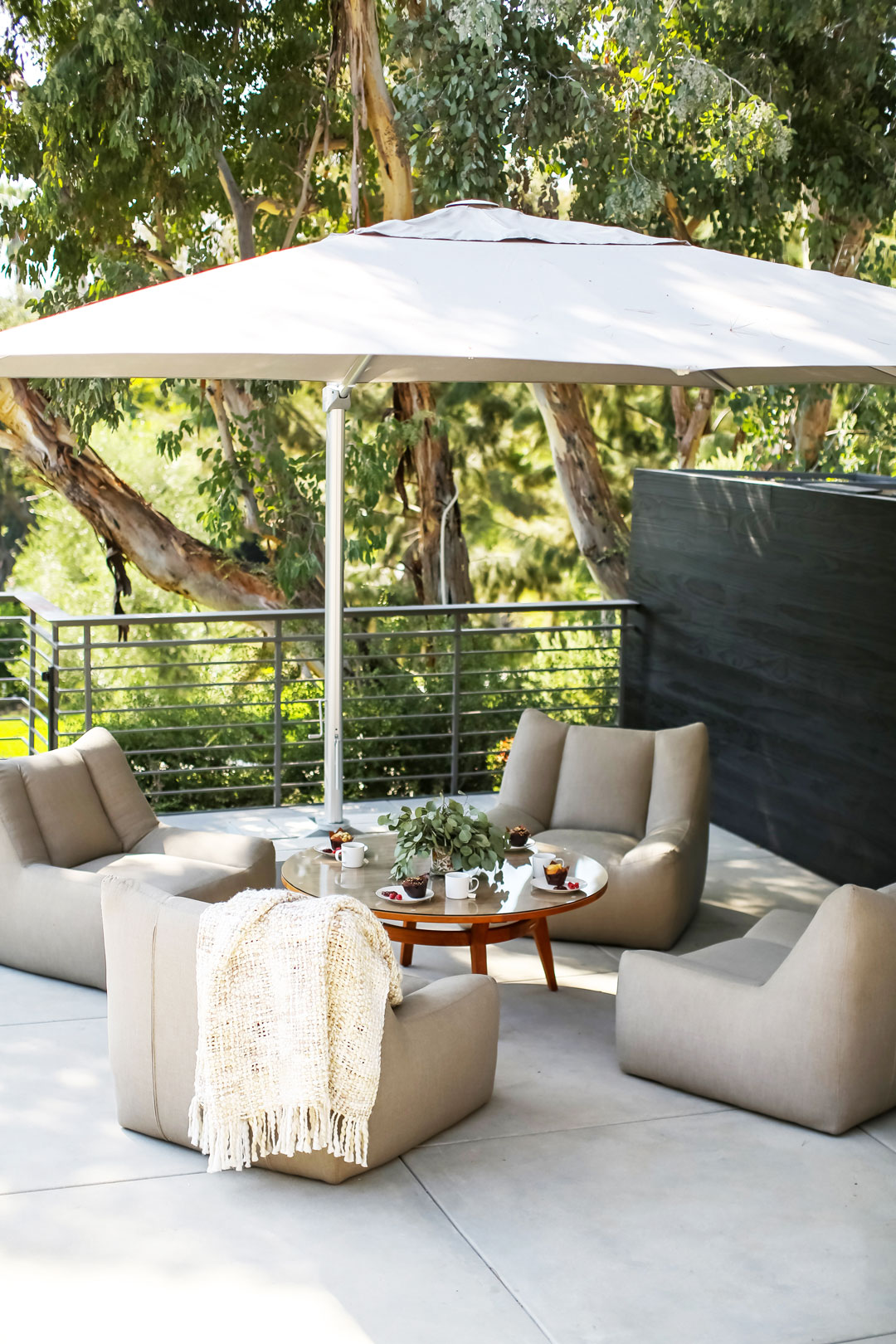 Balcony patio dining set with large umbrella and large tree