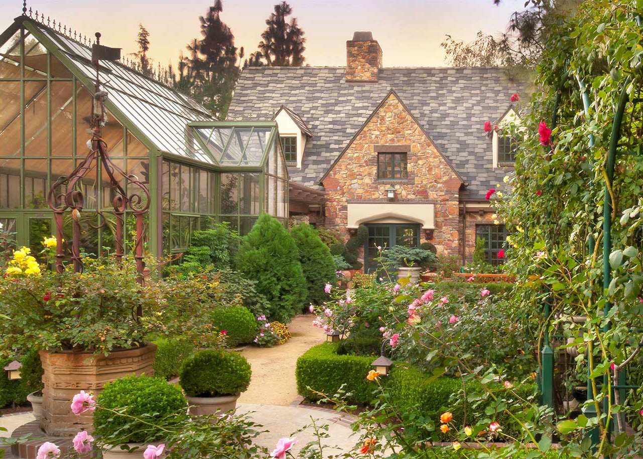 English Tudor home with lush garden and greenhouse