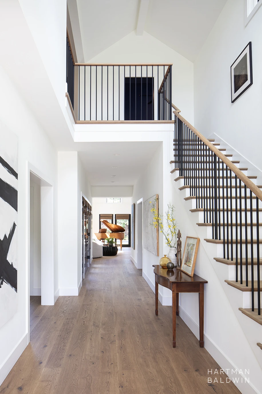 Contemporary Modern Farmhouse-style entryway with a hallway leading to the great room and stairs heading up to the second floor