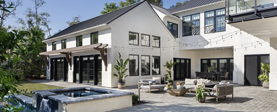 New custom LA modern farmhouse-style home and backyard with pool, spa, string lights, and outdoor furniture