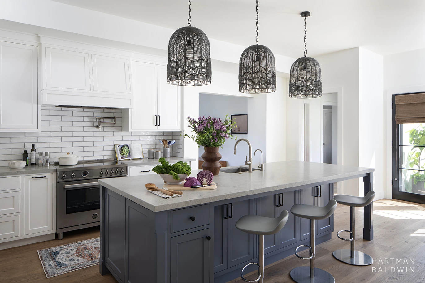 New custom Modern Farmhouse-style kitchen with blue and white painted cabinetry, woven basket-style pendant lights, and white subway tile backsplash
