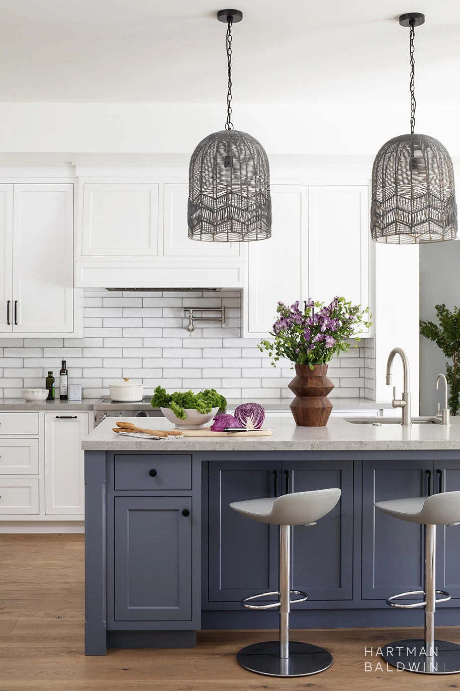 New custom Modern Farmhouse-style kitchen with blue and white painted cabinetry, woven basket-style pendant lights, and white subway tile backsplash