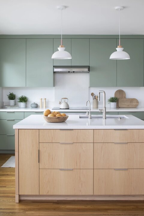 HartmanBaldwin Berlyn Residence Scandinavian Kitchen Remodel - Hartman Baldwin Pre-Launch Scandinavian minimalist-style remodeled kitchen with sage green painted cabinetry, sculptural pendant lights, and multifunctional light maple island with a white quartz countertop