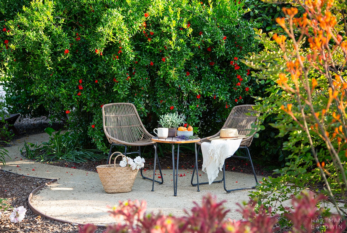HartmanBaldwin Cambridge Residence California Ranch-Style Remodel Garden Table Small table and two chairs surrounded by trees and foliage