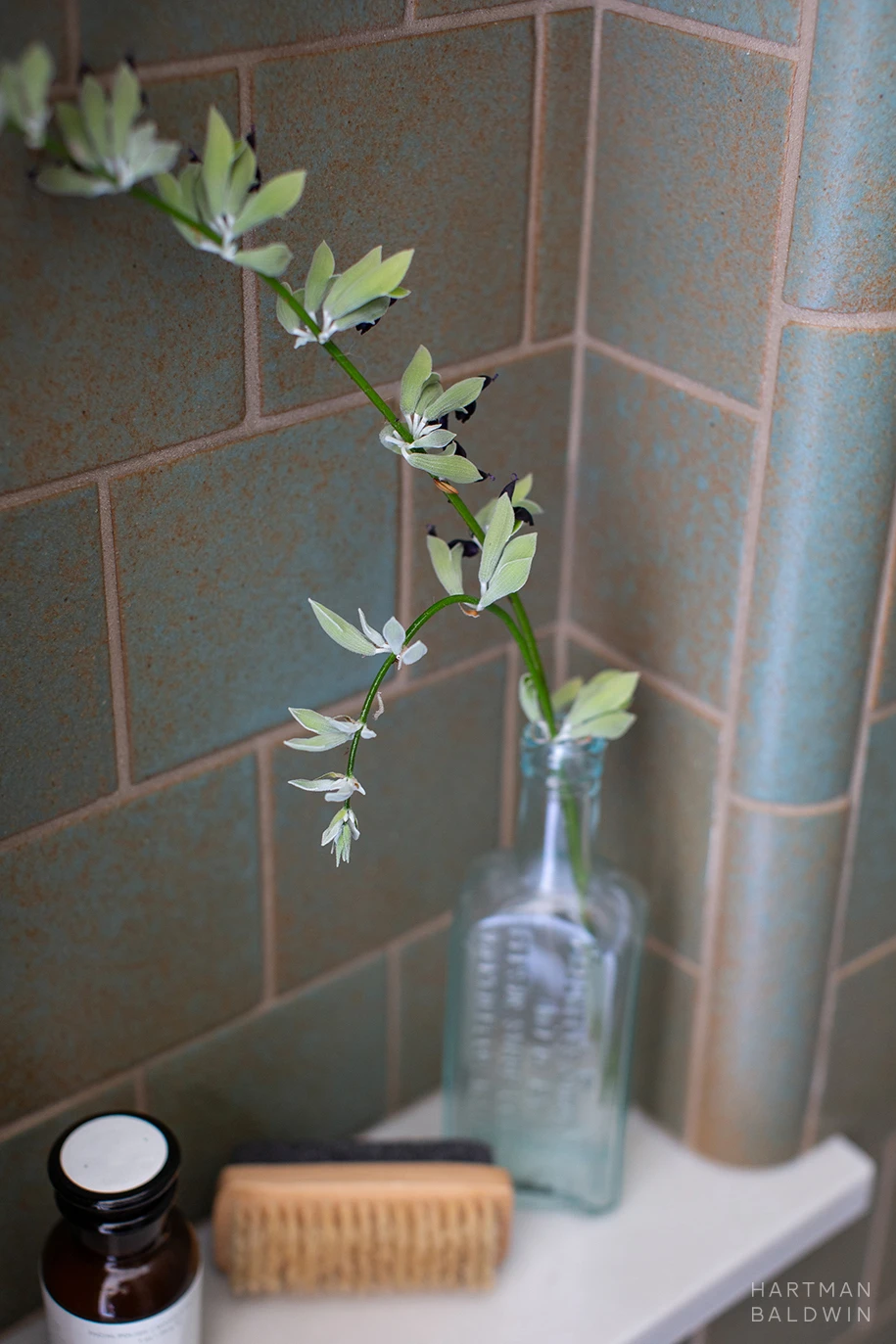 HartmanBaldwin Cambridge Residence California Ranch-Style Remodel Shower Niche Detail Bathroom shower niche detail with turquoise wall tiles and stone shelf