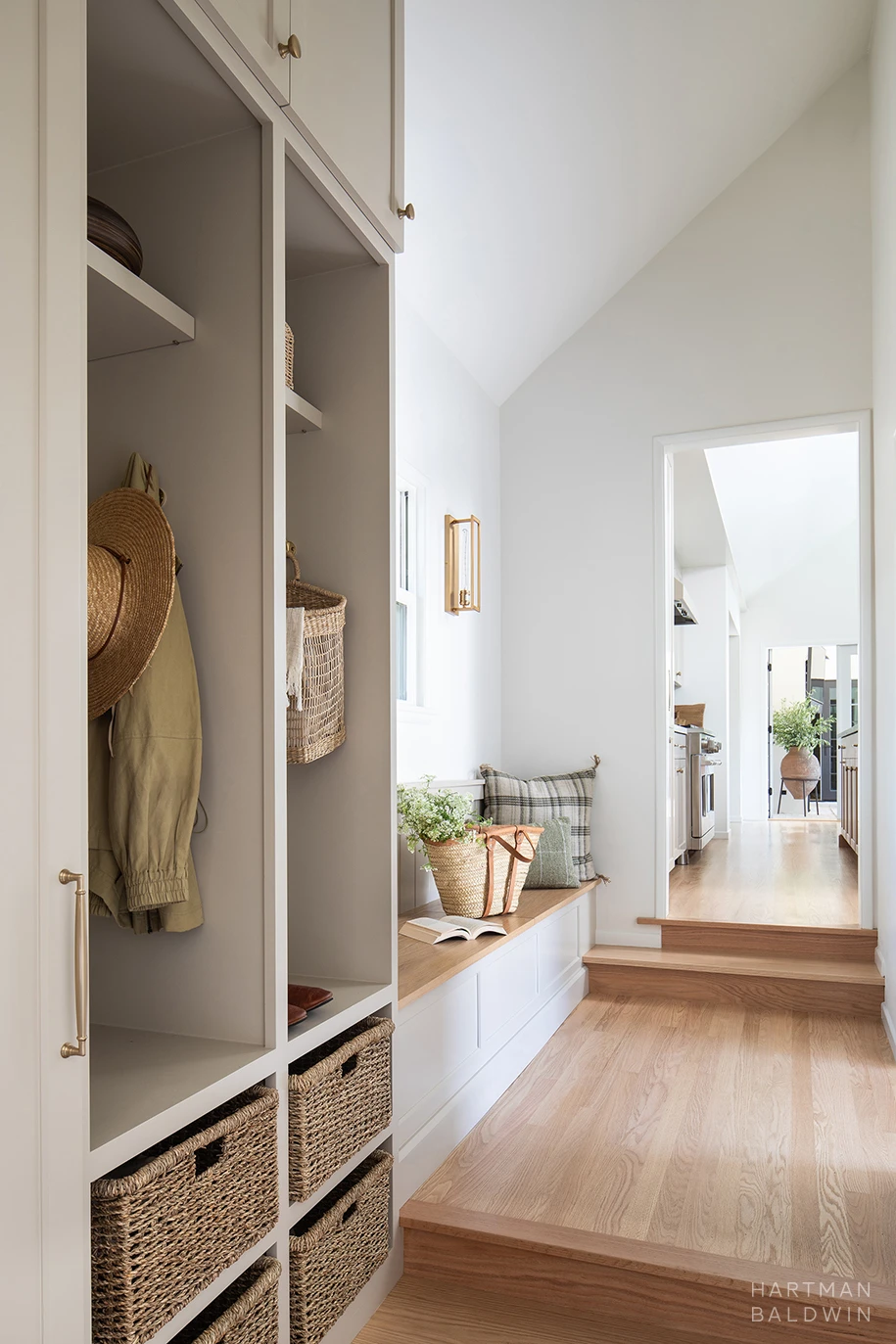 HartmanBaldwin Cambridge Residence California Ranch Mudroom Remodeled hallway with mudroom cabinetry and built-in bench with storage inside