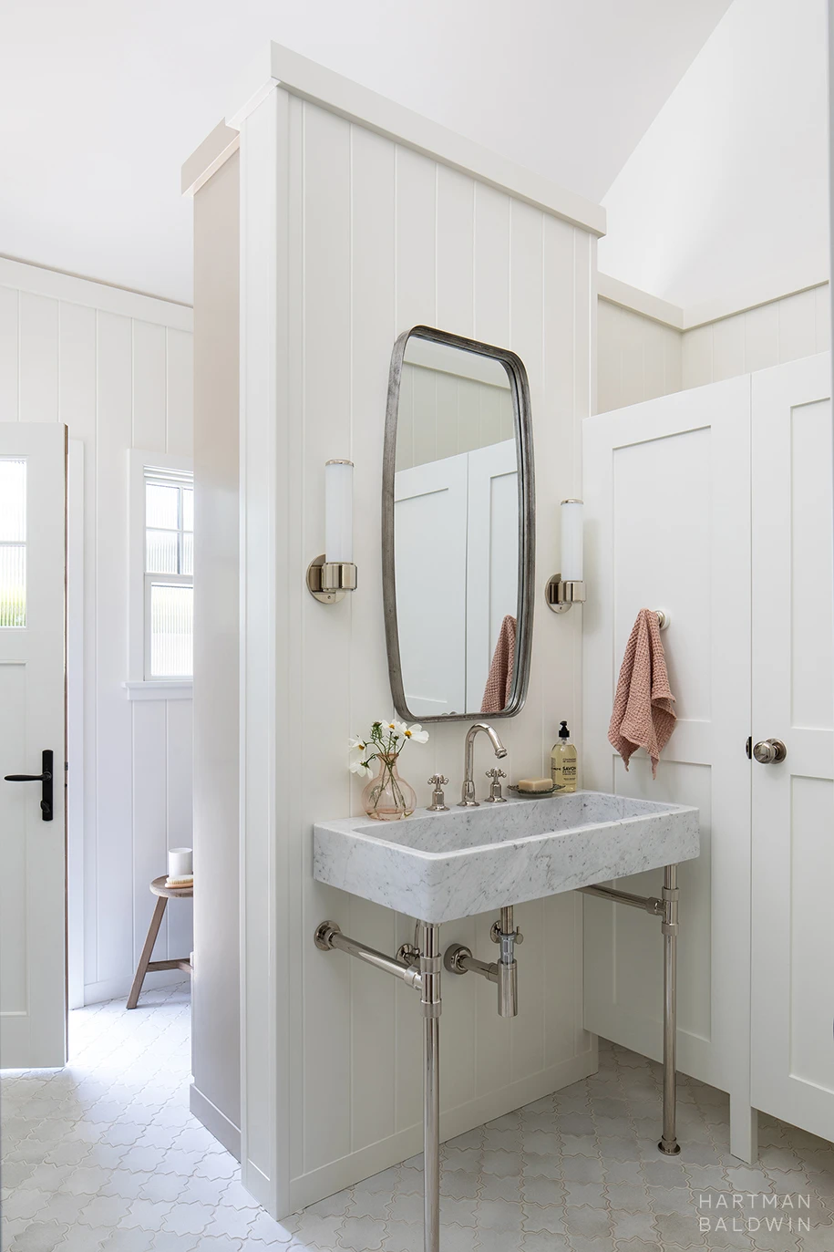 HartmanBaldwin Cambridge Residence California Ranch Pool Bathroom Vanity Elegant sink console vanity inside pool bathroom with shades of white, light grey, and cream