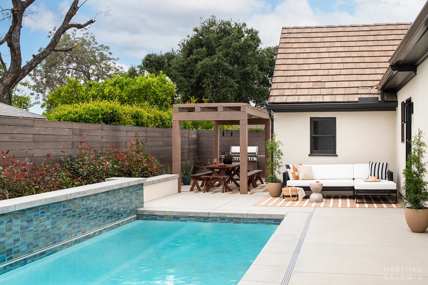 HartmanBaldwin Cambridge Residence California Ranch Backyard Newly remodeled backyard with pool, outdoor furniture, and picnic table with shade structure