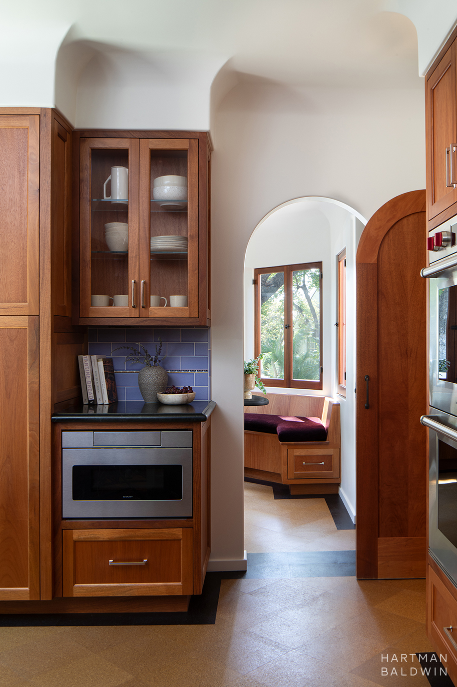 Remodeled Spanish-style kitchen with arched doorway to adjacent breakfast room