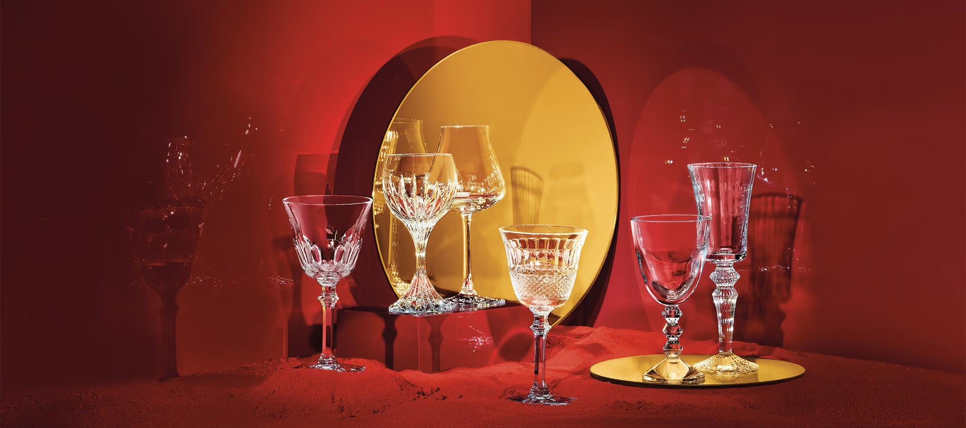 Baccarat Wine Glasses Set Staged - Hartman Baldwin Pre-Launch Decorative crystal wineglasses in front of red and gold background