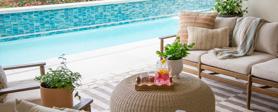 Furnished California room patio with new tiled backyard lap pool seen beyond