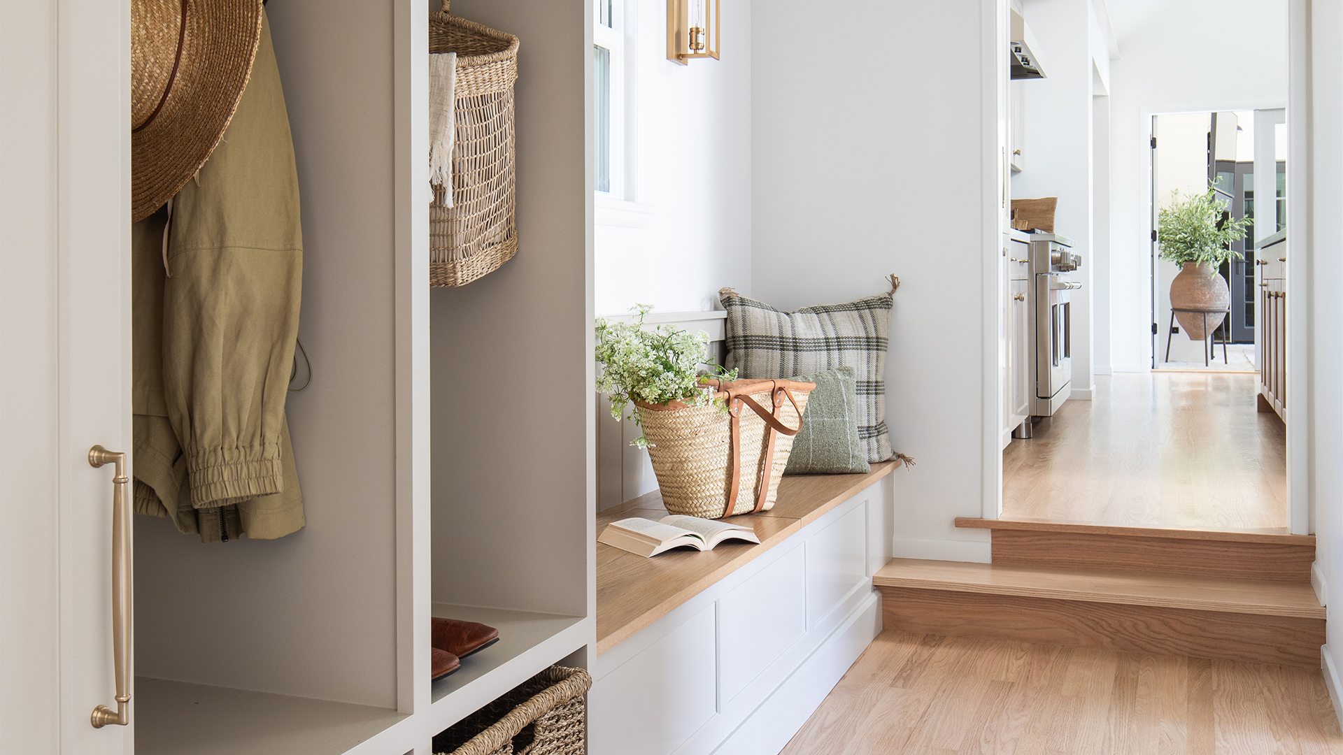 Remodeled hallway with mudroom cabinetry and built-in bench with storage inside