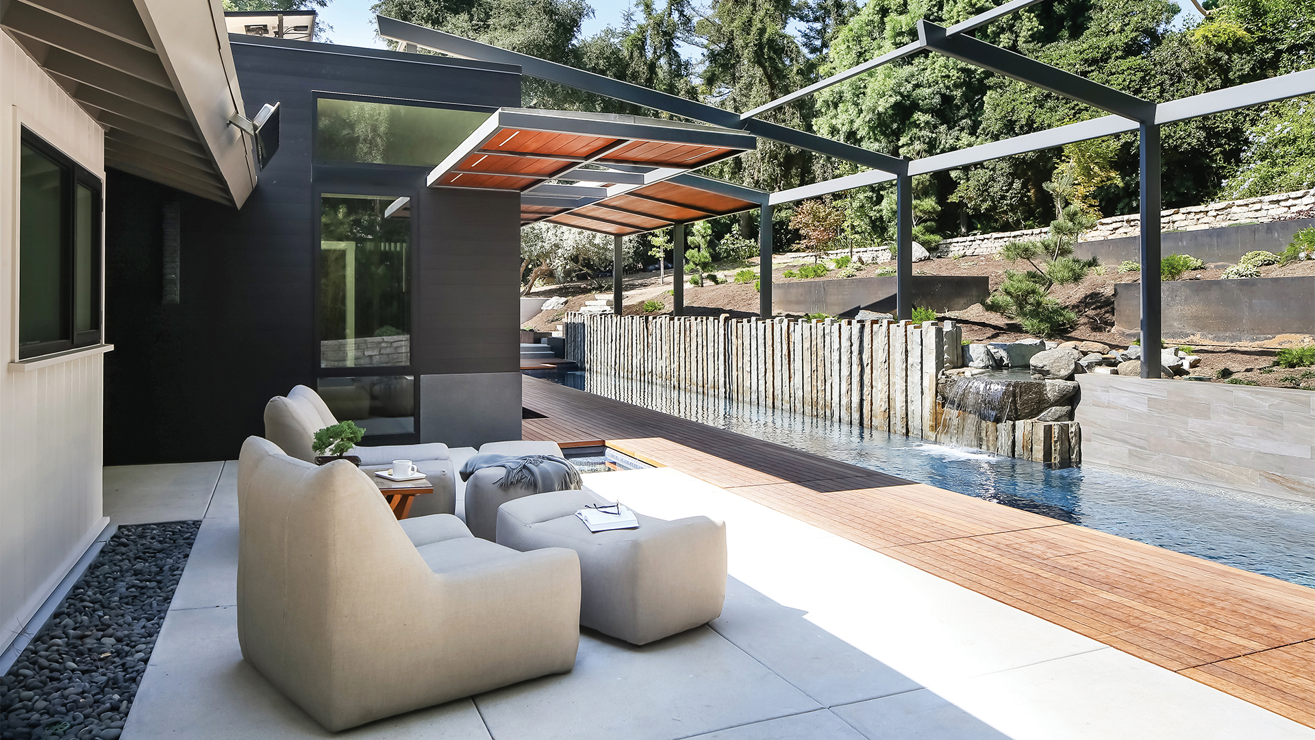 Backyard remodel with lap pool, organic rock water feature, terraced gardens, retractable shade structure, and hot and cold plunge hydrotherapy pools